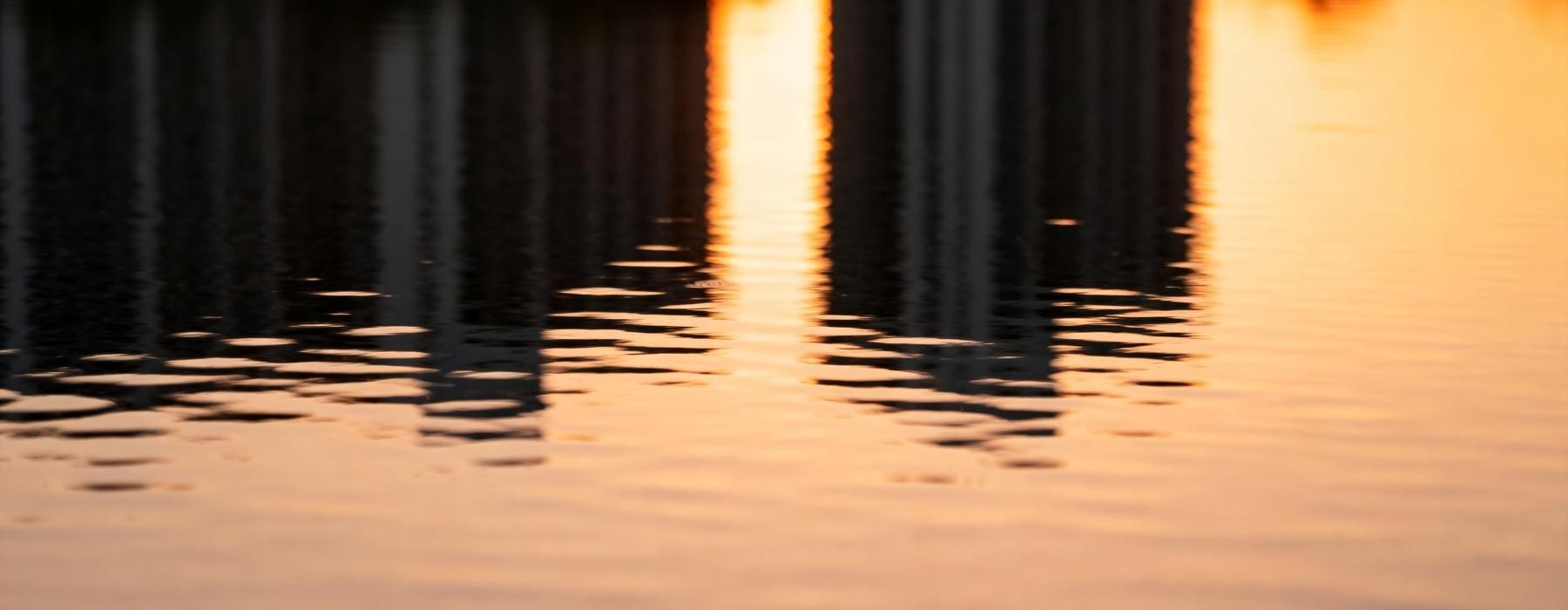 a body of water with a sunset